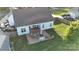 Aerial view of backyard featuring a stone patio with outdoor dining and fire pit at 179 Foy Ln, Statesville, NC 28625