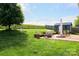 Well-manicured backyard featuring a patio, seating area, and a storage shed at 179 Foy Ln, Statesville, NC 28625