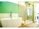 Modern bathroom featuring a soaking tub, glass shower, and shiplap accent wall at 179 Foy Ln, Statesville, NC 28625