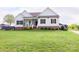 Spacious lawn enhances this two-story home with a charming front porch and contrasting shutters at 179 Foy Ln, Statesville, NC 28625
