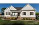 Charming home with white siding, brown shutters, brick foundation and inviting front porch at 179 Foy Ln, Statesville, NC 28625