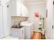 Functional laundry room featuring white cabinets, a utility sink, and modern washer and dryer at 179 Foy Ln, Statesville, NC 28625