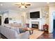 Cozy living room featuring a fireplace, large sectional sofa, and modern decor at 179 Foy Ln, Statesville, NC 28625