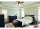 Bright main bedroom boasts a tray ceiling, dark wood furniture and ample natural light at 179 Foy Ln, Statesville, NC 28625