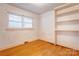 Bedroom with wood floors, trim, and built in shelving at 191 Scenic Ne Dr, Concord, NC 28025