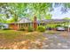 Charming brick home with a carport and mature trees providing shade at 191 Scenic Ne Dr, Concord, NC 28025