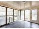 Enclosed sunroom with gray tiled floors, lots of windows and natural light, with a door for exterior access at 191 Scenic Ne Dr, Concord, NC 28025