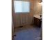Bathroom featuring tile floors, a single sink vanity, and a window for natural light at 201 Trinity St, Clover, SC 29710