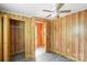 Bedroom featuring neutral wood walls, vinyl flooring and view of closet space and doorway at 201 Trinity St, Clover, SC 29710