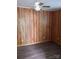 Bedroom featuring wood paneling, a ceiling fan, and vinyl flooring at 201 Trinity St, Clover, SC 29710
