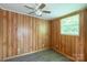 Bedroom featuring neutral wood walls, vinyl flooring, a window, and a ceiling fan at 201 Trinity St, Clover, SC 29710