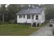 A charming home with white siding, a well-maintained lawn, and a gravel driveway at 201 Trinity St, Clover, SC 29710