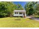 Charming single-story home with white siding, black shutters, and a well-maintained lawn at 201 Trinity St, Clover, SC 29710