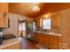 Cozy kitchen with wood cabinetry, stainless steel refrigerator, and hardwood flooring at 201 Trinity St, Clover, SC 29710