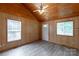 Bright living room with hardwood walls and floors, and large, light-filled windows at 201 Trinity St, Clover, SC 29710
