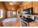 An open-concept living space boasts wood finishes and modern appliances at 201 Trinity St, Clover, SC 29710