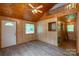 Cozy living space with wood walls, bright windows, and modern gray flooring at 201 Trinity St, Clover, SC 29710