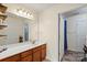 Bright bathroom features a wood vanity, neutral countertops, and a large framed mirror at 202 Pond View Dr, Salisbury, NC 28147