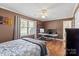 Bedroom featuring a window, wood floors, crown molding, and a desk with monitors at 202 Pond View Dr, Salisbury, NC 28147