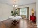 Elegant dining room with hardwood floors, chandelier lighting, and a large window with pleasant outdoor views at 202 Pond View Dr, Salisbury, NC 28147
