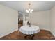 Elegant dining room with hardwood floors, chandelier lighting, and a large window with pleasant outdoor views at 202 Pond View Dr, Salisbury, NC 28147