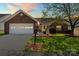 Charming single-story home featuring a brick facade, well-manicured lawn and attached garage with carriage door at 202 Pond View Dr, Salisbury, NC 28147