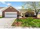Charming single-story home featuring a brick facade, well-manicured lawn and attached garage with carriage door at 202 Pond View Dr, Salisbury, NC 28147