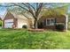 Charming single-story home featuring a brick facade, well-manicured lawn and attached garage with carriage door at 202 Pond View Dr, Salisbury, NC 28147