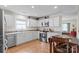 Bright kitchen featuring stainless steel appliances, white cabinets, and a cozy breakfast nook with a table at 202 Pond View Dr, Salisbury, NC 28147