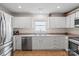 Bright kitchen featuring stainless steel appliances, white cabinets, and a cozy breakfast nook with a table at 202 Pond View Dr, Salisbury, NC 28147