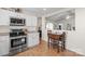 Bright kitchen featuring stainless steel appliances, white cabinets, and a cozy breakfast nook with a table at 202 Pond View Dr, Salisbury, NC 28147