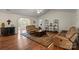 Bright living room with vaulted ceiling, hardwood floors, comfortable leather seating, and decorative shelving at 202 Pond View Dr, Salisbury, NC 28147