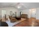 Spacious living room featuring hardwood floors, neutral walls, vaulted ceiling and comfortable leather seating at 202 Pond View Dr, Salisbury, NC 28147