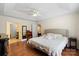 Spacious main bedroom with tray ceiling, hardwood floors, large window with seating area, and ensuite bathroom at 202 Pond View Dr, Salisbury, NC 28147