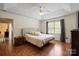 Spacious main bedroom with tray ceiling, hardwood floors, large window with seating area, and ensuite bathroom at 202 Pond View Dr, Salisbury, NC 28147