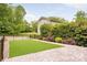 Professionally landscaped backyard features a manicured lawn with pavers on one side at 2117 Roslyn Ave, Charlotte, NC 28208