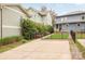 Long driveway leads to spacious backyard featuring manicured lawn and professional landscaping at 2117 Roslyn Ave, Charlotte, NC 28208