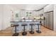 Modern kitchen featuring white cabinets, stainless steel appliances, subway tile backsplash, and bar stool seating at 2117 Roslyn Ave, Charlotte, NC 28208