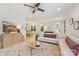 Sunlit living room featuring hardwood floors, a comfortable sofa, modern decor, and an open flow to the dining area at 2117 Roslyn Ave, Charlotte, NC 28208
