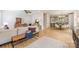 Open-concept layout with hardwood floors, view of the kitchen, white walls, and comfortable seating arrangements at 2117 Roslyn Ave, Charlotte, NC 28208