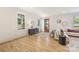 Bright living room with hardwood floors, large windows, recessed lighting, modern furniture, and stylish decor at 2117 Roslyn Ave, Charlotte, NC 28208