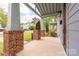 Inviting covered porch with brick pillars offers a charming entryway to the home at 2117 Roslyn Ave, Charlotte, NC 28208