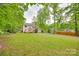 Expansive backyard featuring a lush lawn, mature trees, and a wooden deck perfect for outdoor gatherings at 2345 Sparrow Dr, Rock Hill, SC 29732
