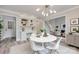 Inviting breakfast nook with a white round table, modern chandelier, and built in desk at 2345 Sparrow Dr, Rock Hill, SC 29732