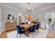 Formal dining room with stylish chandelier, wood table, blue chairs, and detailed trim at 2345 Sparrow Dr, Rock Hill, SC 29732