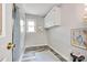 Practical laundry room with overhead cabinets, gray vinyl flooring, and ample natural light at 2345 Sparrow Dr, Rock Hill, SC 29732