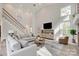 Bright living room with tall ceilings, hardwood floors, staircase, and comfortable seating at 2345 Sparrow Dr, Rock Hill, SC 29732