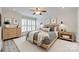 Cozy bedroom with neutral decor, a wooden bed frame, and bright natural light at 2345 Sparrow Dr, Rock Hill, SC 29732