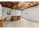 Unfinished basement space with two windows and a work bench at 2410 Armstrong Park Dr, Gastonia, NC 28054