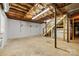 Spacious unfinished basement with stairs and exposed ceiling at 2410 Armstrong Park Dr, Gastonia, NC 28054